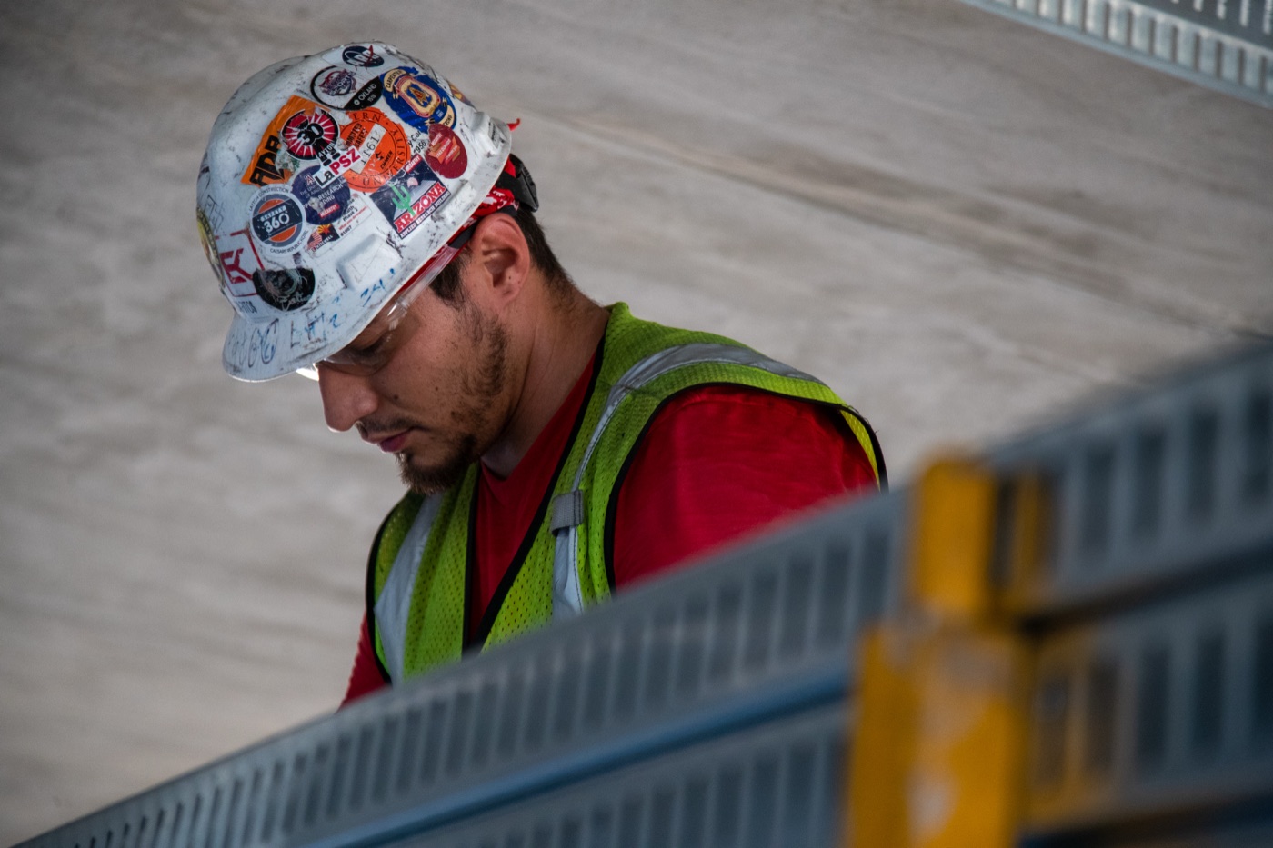 Tradesman in safety gear focused on the work