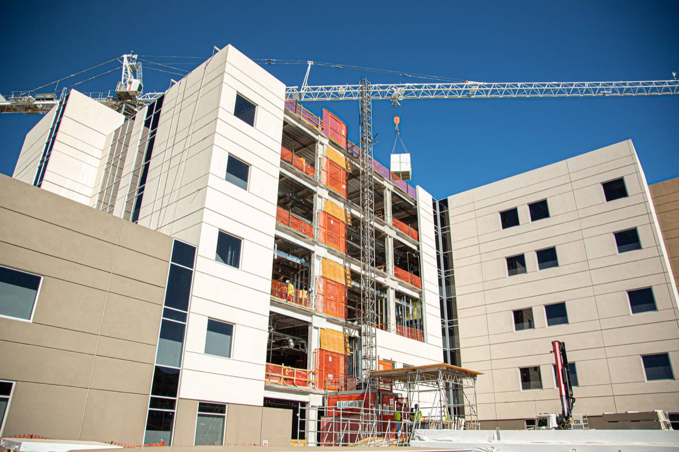Commercial building under construction with tower crane